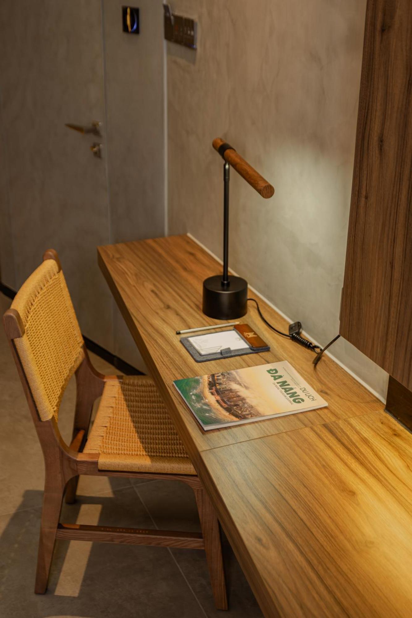M Hotel Danang ภายนอก รูปภาพ A desk with a magazine on it